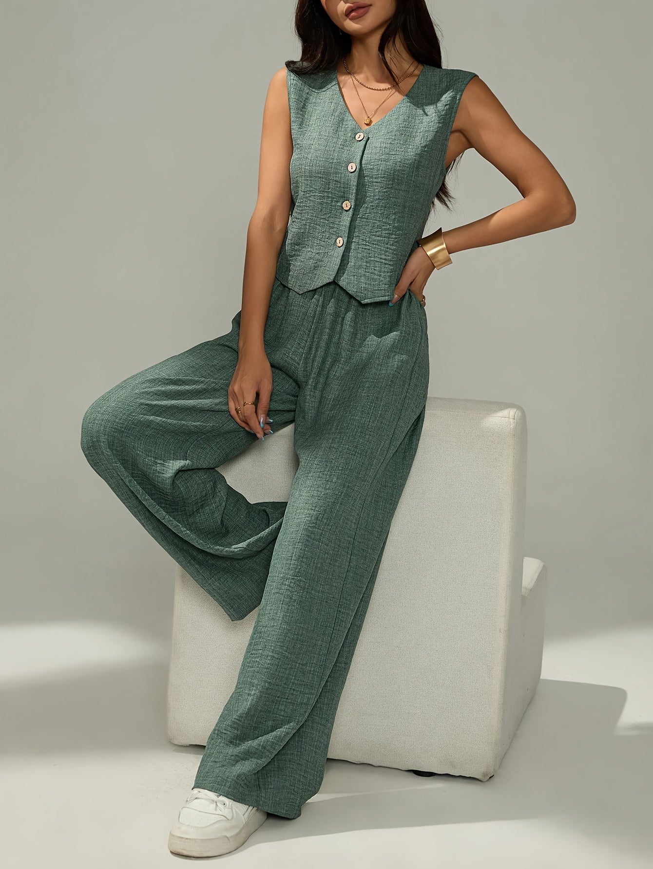 Women's elegant two-piece set - sleeveless top and wide-leg pants with button details