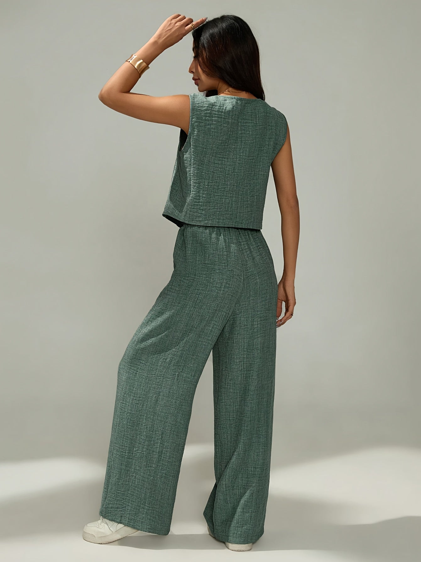 Women's elegant two-piece set - sleeveless top and wide-leg pants with button details