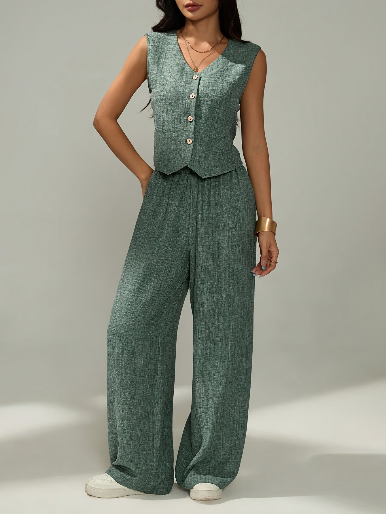 Women's elegant two-piece set - sleeveless top and wide-leg pants with button details